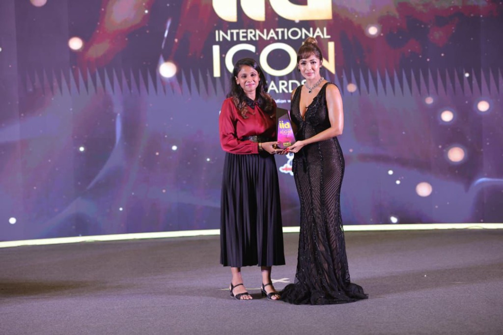 Malaika Arora standing with winner presenting award